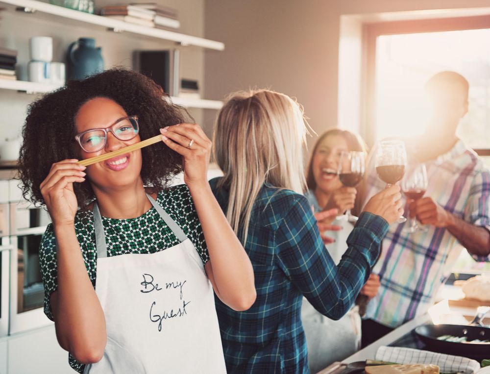 Woman making funny face with pasta
