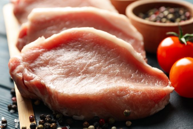 Composition with raw meat for steak and ingredients on wooden background