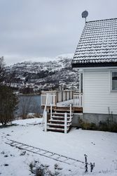 Small country house on lake in winter