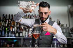 Bartender using double straining technique