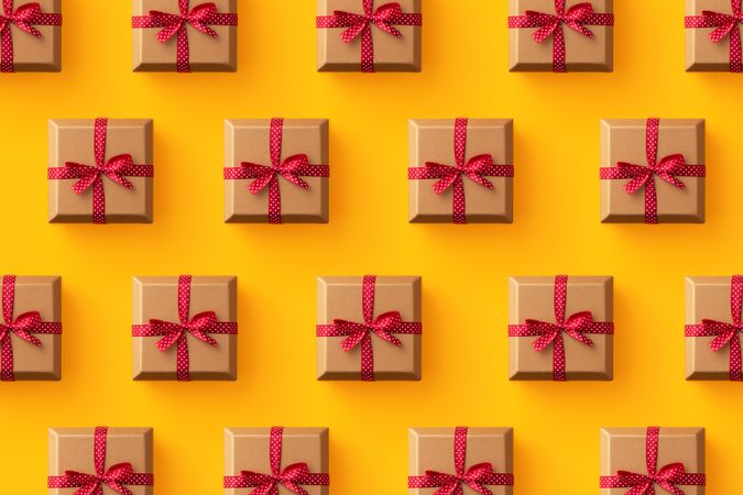 Brown boxes with red dotted ribbon on an orange background
