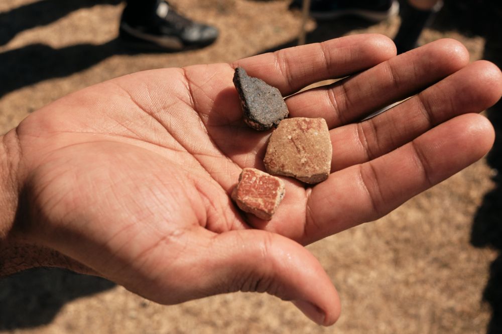 Hand holding three different rocks