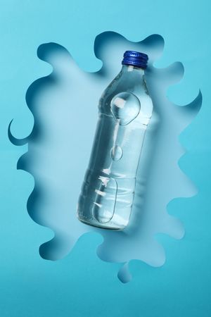 Looking down at water bottle in swirly blue frame