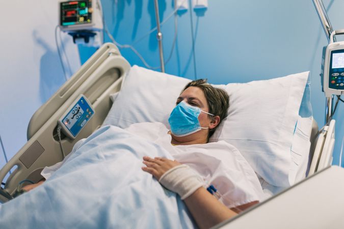 Plump woman in mask in hospital ward