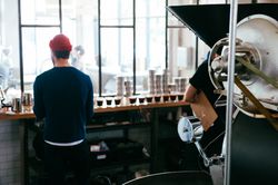 Back view of master coffee roaster at coffee shop