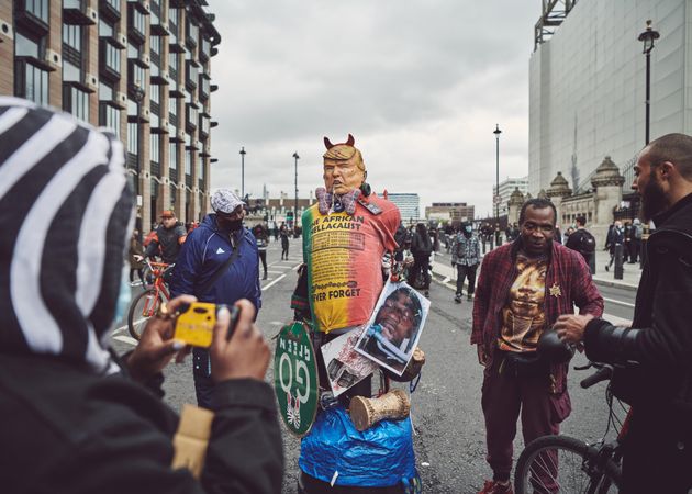 London, England, United Kingdom - June 6th, 2020: Group of people with Donald Trump effigy