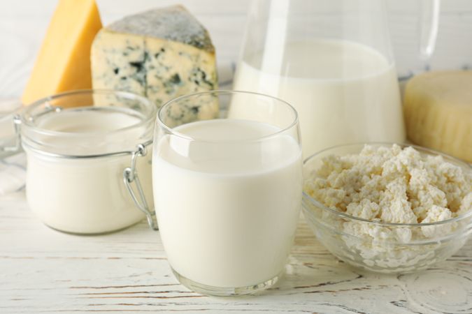 Different dairy products on wooden background, close up