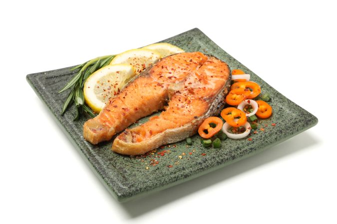 Plate with grilled salmon isolated on blank background
