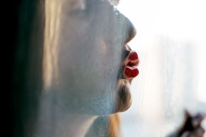 Stylish woman kissing glass