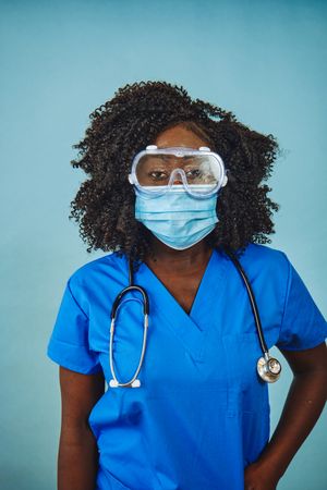 Close up of serious Black female medical professional wearing a face mask and protective eyewear