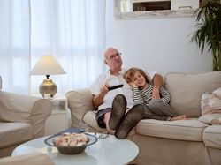 Grandfather with boy watching movie