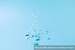 Variety of medications falling on blue backdrop bxVlX5