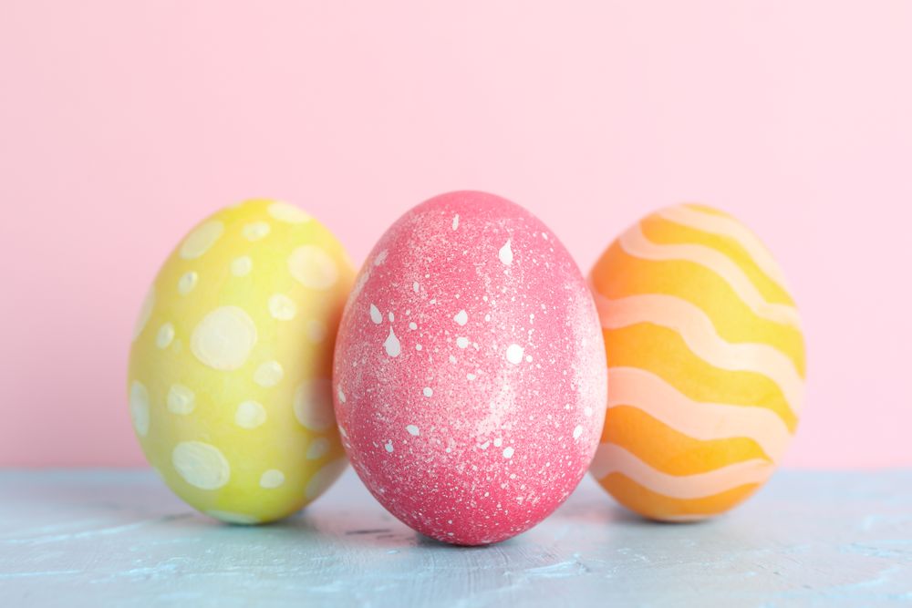 Decorated Easter eggs on color background, closeup. Space for text