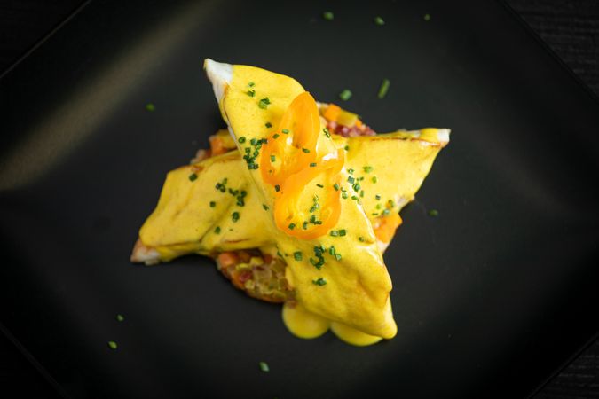 Corvina with yellow pepper sauce in plate