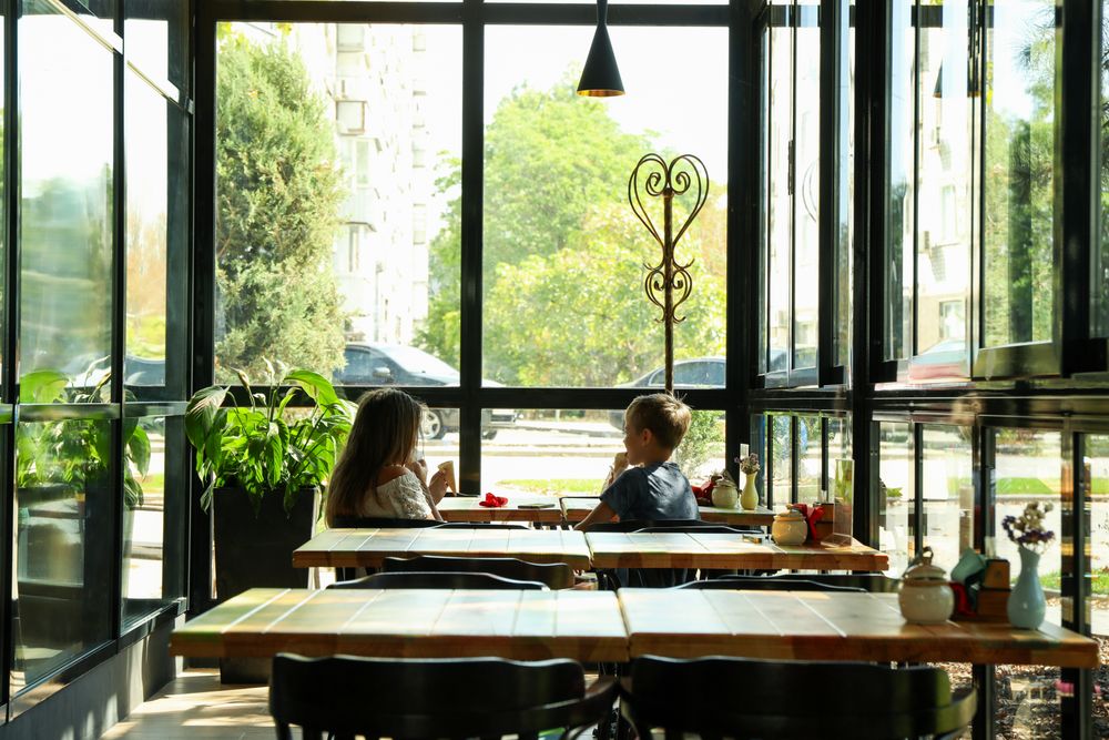Two children eat ice cream in restaurant