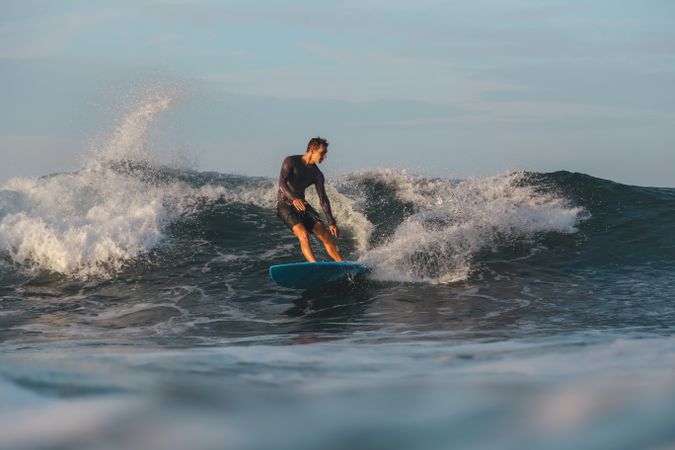 Man on surf board on waving water