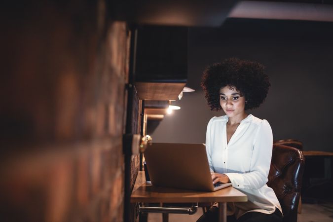 Businesswoman working late on laptop in office
