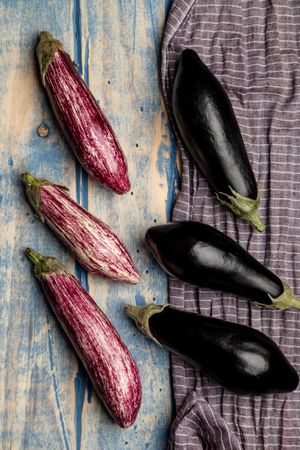 Ripe eggplants on shabby tabletop