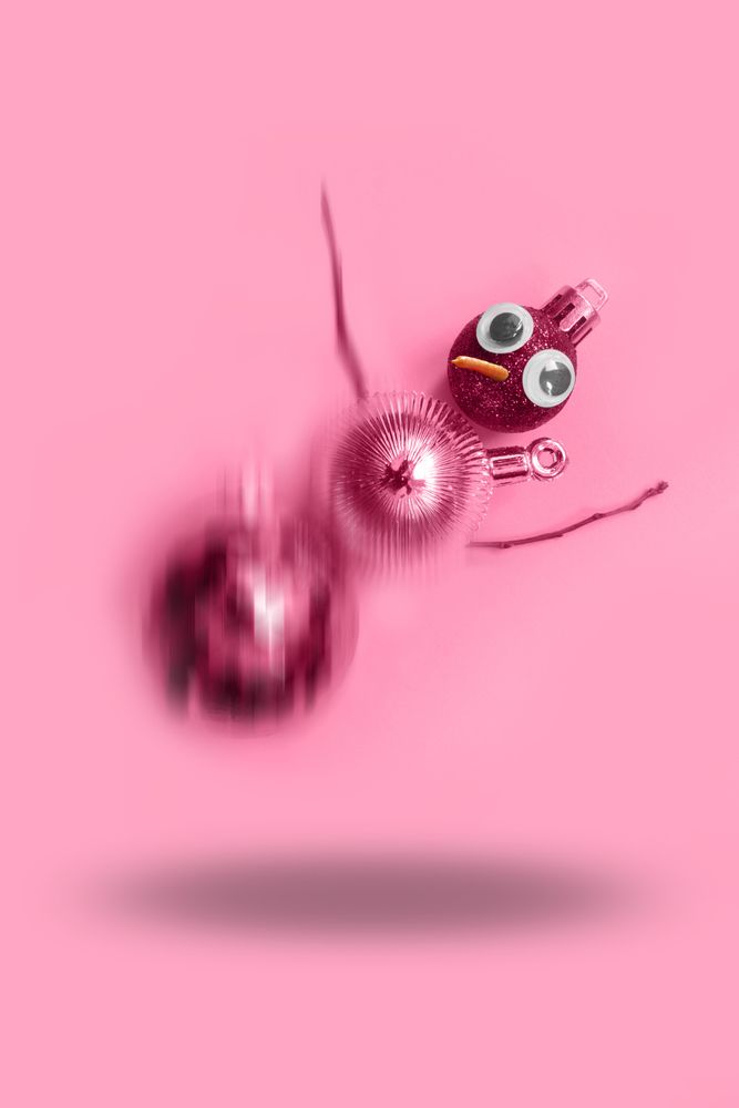 Falling pink snowman made out of Christmas decorations