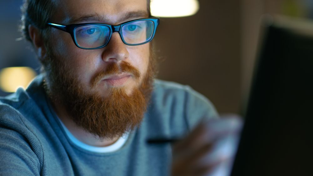 Talented Young Concept Artist Drawing on a Digital Pen Display Tablet While Sitting at His Working Place in Modern Loft Office.