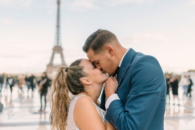 Happy newlyweds in wedding clothing kissing