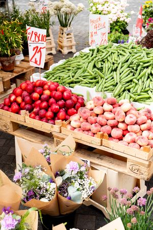 Fresh fruit, vegetables and flowers in market stall