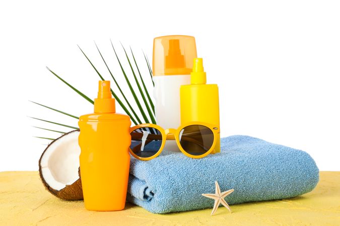 Summer vacation accessories on color table isolated on plain background. Happy holidays