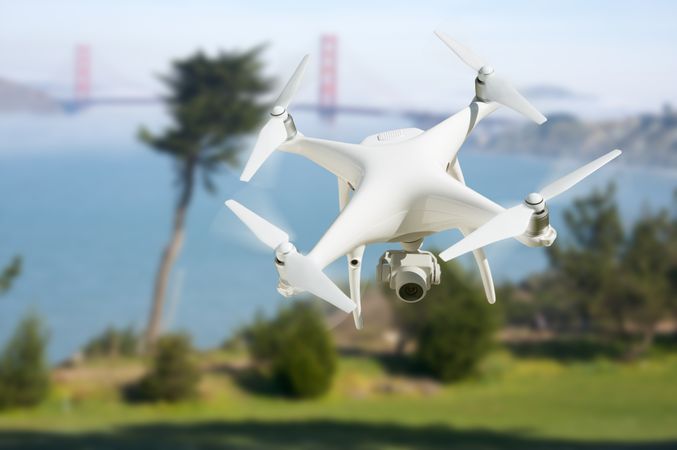 Unmanned Aircraft System (UAV) Quadcopter Drone In The Air Near The San Francisco Golden Gate Bridge.