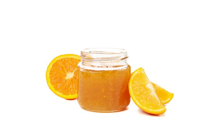 Delicious orange jam isolated on plain background