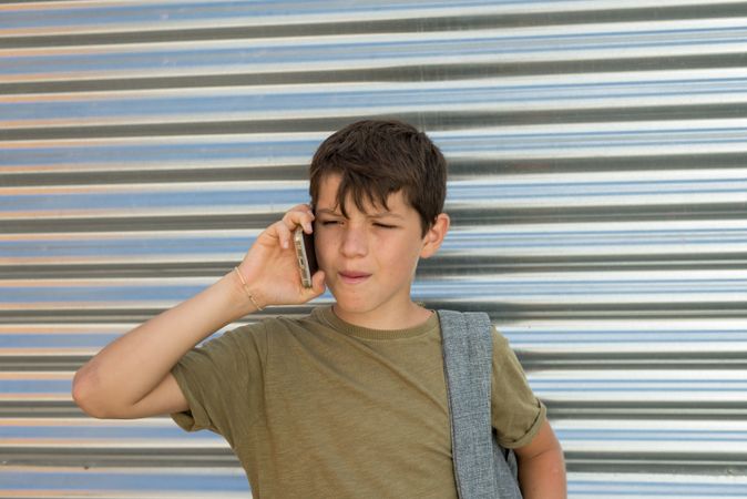Teenager showing consternation during conversation on smart phone