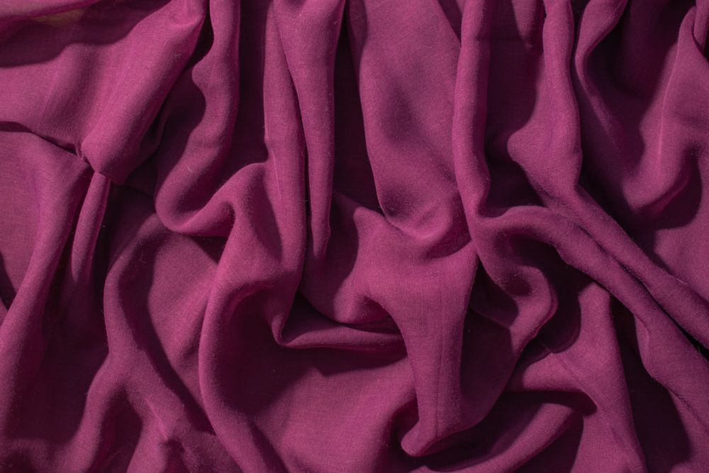 Soft purple fabric wavy crumpled background abstract.