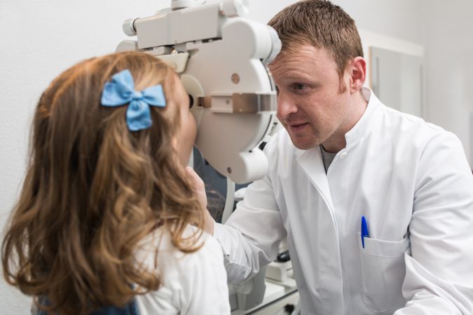 Optician testing a girl's eyes