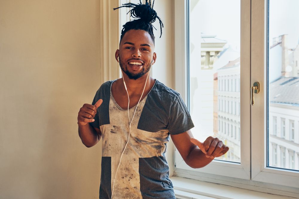 Cheerful Black male listening to music