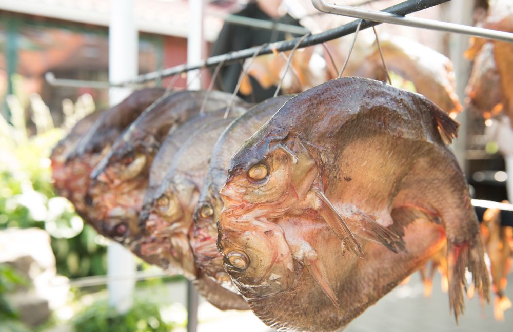 Cut open fresh sun dried fish on market