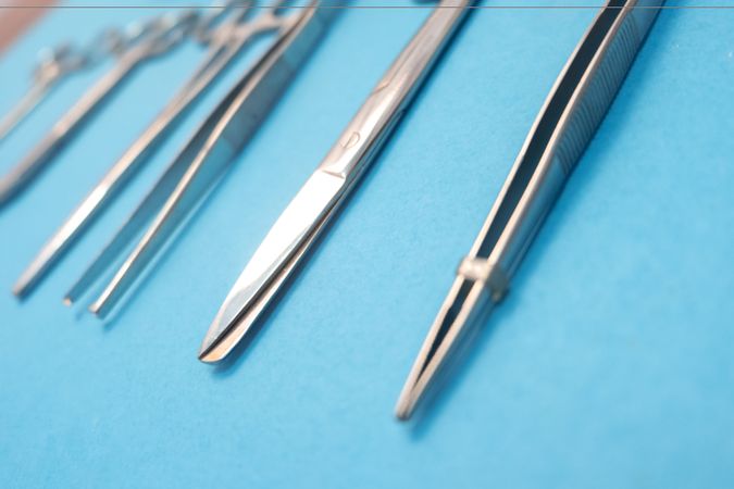 Set of Surgery Instrument over blue background, Scissors and forceps