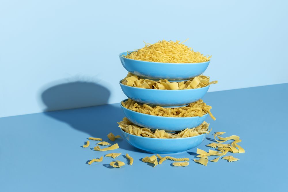 Raw pasta assortments in blue plates