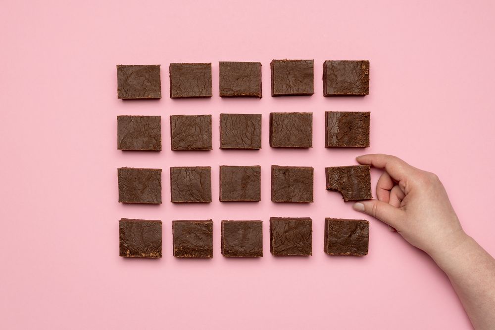 Woman hand grabbing a piece of fudge