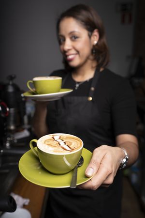 Latina woman with cappuccino cups