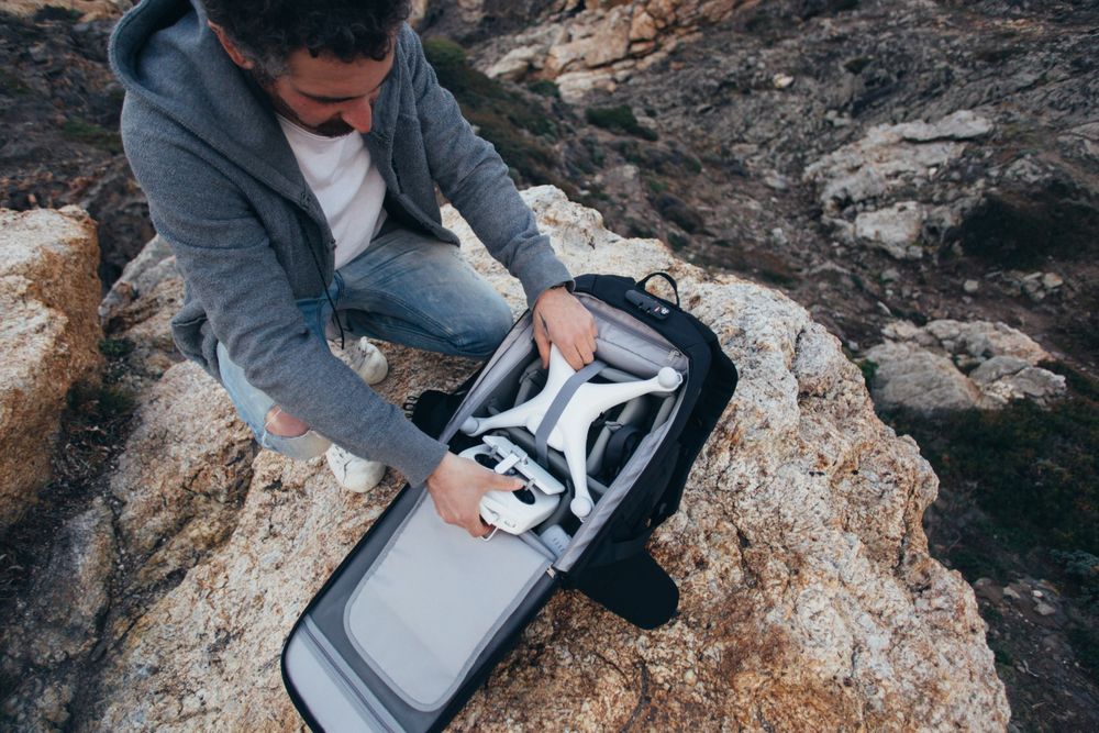 Man opening bag with drone equipment