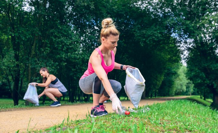 Woman picking up trash doing plogging