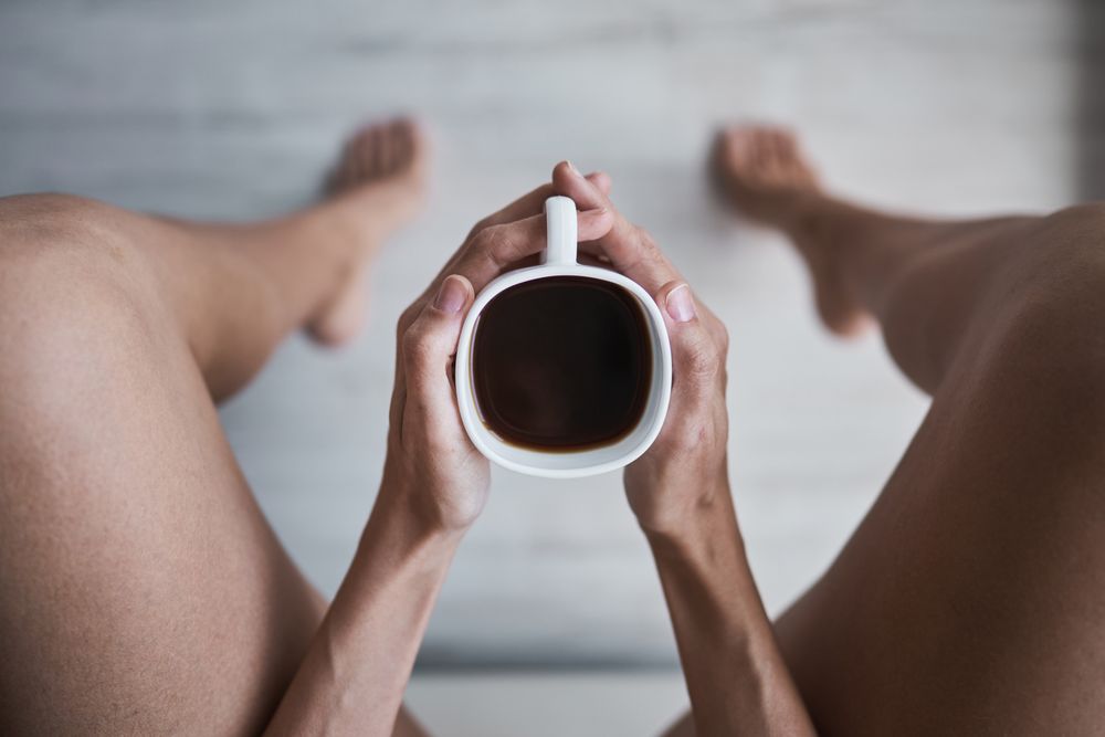 Unrecognizable woman with coffee cup at home