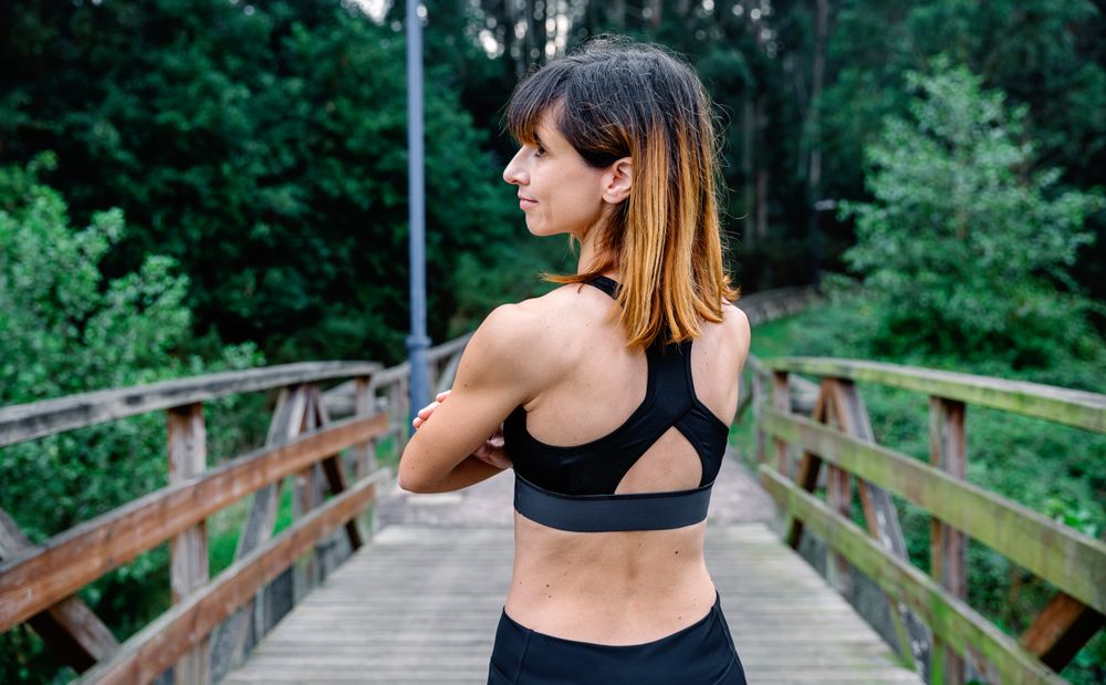 Sportswoman posing on her back looking aside