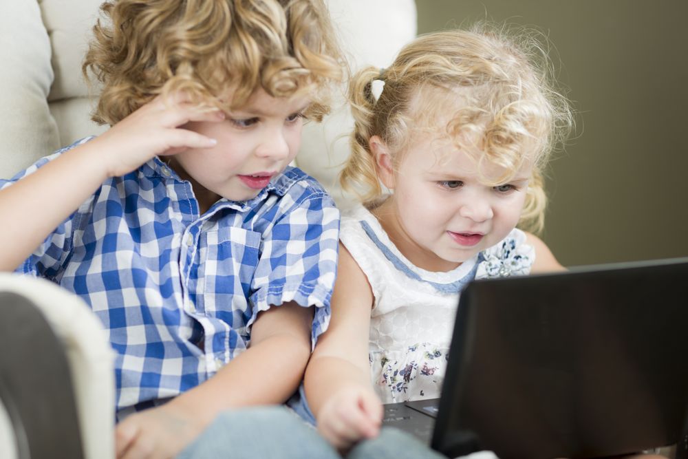 Brother and Sister Using Their Computer Laptop Together
