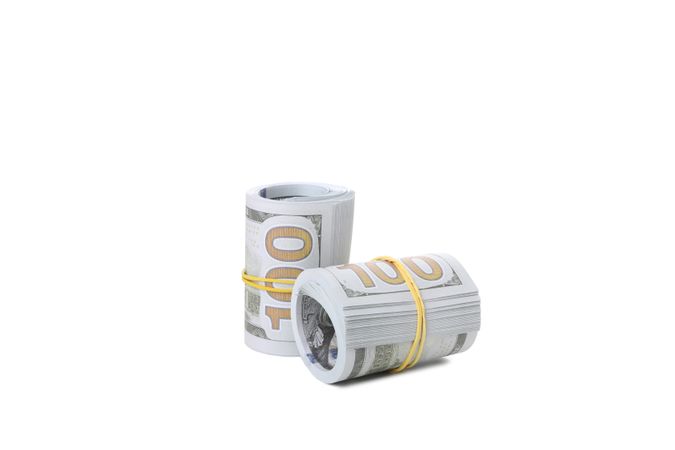 Stacks of American cash money, isolated on light background