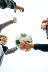 Three generations playing with soccer ball