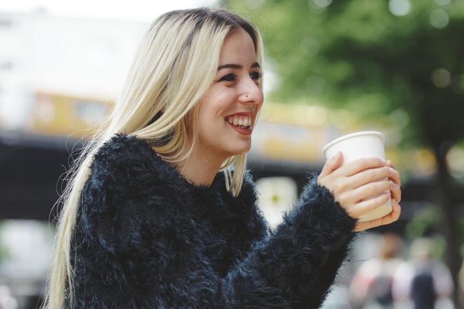 woman drinking coffee in street cafe