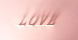 “Love” written in shadow on pink background