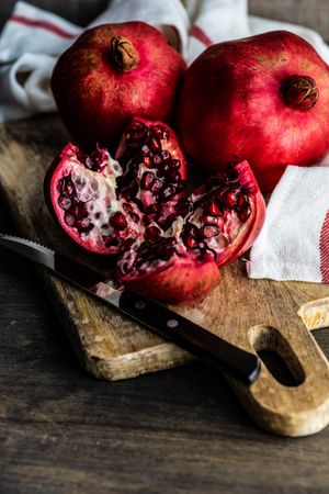 Fresh cut pomegranate on board with dish towel
