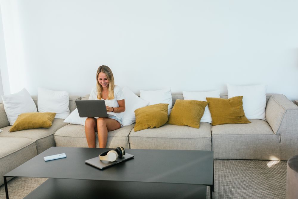 Woman browsing laptop on couch