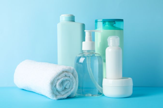 Body care products on blue background. Personal hygiene